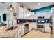 Bright kitchen features white cabinets, stainless appliances, granite countertops and blue backsplash at 16111 Sunny Day Dr, Bradenton, FL 34211