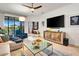 Bright living room with a view of the outdoor space, comfortable seating, and modern entertainment setup at 16111 Sunny Day Dr, Bradenton, FL 34211