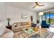 Comfortable living room with natural light, stylish decor, and open access to the outdoor patio at 16111 Sunny Day Dr, Bradenton, FL 34211
