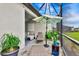 Inviting covered patio with a lounge area, potted plants, and outdoor decor for relaxation at 16111 Sunny Day Dr, Bradenton, FL 34211