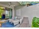 Stylish covered patio with comfortable seating, ceiling fan, and seamless indoor-outdoor flow at 16111 Sunny Day Dr, Bradenton, FL 34211