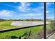 Relaxing view of the pond from the screened patio, showcasing a peaceful outdoor living space at 16111 Sunny Day Dr, Bradenton, FL 34211