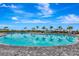 Resort-style pool with palm trees and blue skies in a beautiful community setting at 16111 Sunny Day Dr, Bradenton, FL 34211