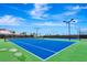 Bright blue community tennis courts under a blue sky for community members to enjoy at 16111 Sunny Day Dr, Bradenton, FL 34211