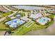 Community aerial view showcasing the clubhouse, pool, tennis courts, bocce ball and scenic lake at 17519 Polo Trl, Lakewood Ranch, FL 34211