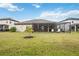 Beautiful backyard featuring a screened-in patio, lush green grass, and an idyllic space for outdoor enjoyment at 17519 Polo Trl, Lakewood Ranch, FL 34211