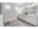 Bright bathroom with double vanity, granite countertops, and modern fixtures at 17519 Polo Trl, Lakewood Ranch, FL 34211