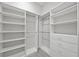 Spacious walk-in closet with adjustable shelving and drawer units for optimal organization at 17519 Polo Trl, Lakewood Ranch, FL 34211