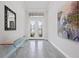 Bright foyer with modern decor, featuring a glass table and decorative mirror at 17519 Polo Trl, Lakewood Ranch, FL 34211