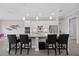 Bright kitchen with an island, four chairs, and white cabinets at 17519 Polo Trl, Lakewood Ranch, FL 34211