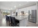 Elegant kitchen with granite countertops, stainless steel appliances, a kitchen island, and a cozy dining area at 17519 Polo Trl, Lakewood Ranch, FL 34211