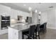 Modern kitchen featuring granite countertops, stainless steel appliances, and seating at the island at 17519 Polo Trl, Lakewood Ranch, FL 34211