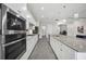 Gourmet kitchen featuring stainless steel appliances and a large island with seating and convenient access to other rooms at 17519 Polo Trl, Lakewood Ranch, FL 34211