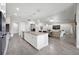 Open-concept kitchen featuring an island with sink, stainless steel appliances, and seamless flow to the living area at 17519 Polo Trl, Lakewood Ranch, FL 34211