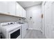 Laundry room featuring white cabinets, washer and dryer, and tile floors at 17519 Polo Trl, Lakewood Ranch, FL 34211