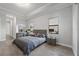 Comfortable main bedroom featuring neutral decor, tray ceilings, and soft natural light at 17519 Polo Trl, Lakewood Ranch, FL 34211