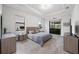 Serene main bedroom with tray ceilings, access to the lanai, and gray color palette at 17519 Polo Trl, Lakewood Ranch, FL 34211
