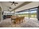 Covered patio with dining table, ceiling fans, and water view at 17519 Polo Trl, Lakewood Ranch, FL 34211