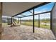 Relaxing screened patio with brick pavers and two lounge chairs overlooking a beautiful pond at 17519 Polo Trl, Lakewood Ranch, FL 34211