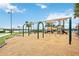 Community playground boasts a swing set, slides, and adjacent lake, providing fun and scenic outdoor activities at 17519 Polo Trl, Lakewood Ranch, FL 34211