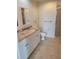Well-lit bathroom featuring double sinks, a toilet, and a glass-enclosed shower at 1771 Ringling Blvd # 902, Sarasota, FL 34236