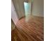 Bedroom featuring light wood floors, closet, and an ensuite bathroom at 1771 Ringling Blvd # 902, Sarasota, FL 34236