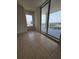 Bright bedroom featuring tiled floor, large windows and sliding doors to a balcony with city views at 1771 Ringling Blvd # 902, Sarasota, FL 34236