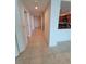 Bright hallway featuring neutral tile flooring and leads to an open kitchen view at 1771 Ringling Blvd # 902, Sarasota, FL 34236