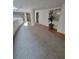 Wide, bright hallway featuring modern carpeting, accent lighting, and elegant architectural details at 1771 Ringling Blvd # 902, Sarasota, FL 34236
