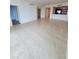 Large living room area with tiled floors and an open design to the kitchen at 1771 Ringling Blvd # 902, Sarasota, FL 34236