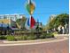 Artistic hourglass sculpture graces the street with greenery, complemented by a clear blue sky in the background at 1771 Ringling Blvd # 902, Sarasota, FL 34236