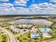 Panoramic aerial view of a Primary-planned community with a clubhouse, pool, tennis and lake at 18032 Polo Trl, Bradenton, FL 34211