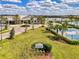 Inviting amenity center with manicured landscaping, tennis courts, and a picturesque lake view at 18032 Polo Trl, Bradenton, FL 34211