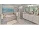 Serene bathroom with soaking tub, glass shower, and granite vanity at 18032 Polo Trl, Bradenton, FL 34211