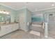 Light-filled bathroom with a soaking tub, glass shower, and double vanity at 18032 Polo Trl, Bradenton, FL 34211