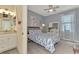 Bedroom and en suite bathroom with bright light, beach decor, and ceiling fan at 18032 Polo Trl, Bradenton, FL 34211