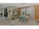 Dining room featuring an industrial chandelier, large windows and an open floor plan at 18032 Polo Trl, Bradenton, FL 34211