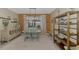Dining room with modern lighting fixture, beige walls, and view of the lake at 18032 Polo Trl, Bradenton, FL 34211