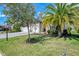 Well-maintained lawn and mature landscaping enhances curb appeal at 18032 Polo Trl, Bradenton, FL 34211
