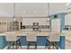 Kitchen island featuring granite countertops, stainless steel appliances, pendant lighting and bar stool seating at 18032 Polo Trl, Bradenton, FL 34211