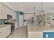 Bright and airy kitchen featuring granite countertops, stainless appliances and white cabinetry at 18032 Polo Trl, Bradenton, FL 34211