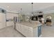 Spacious kitchen with granite island, stainless steel appliances, and seamless flow into the living area at 18032 Polo Trl, Bradenton, FL 34211