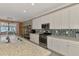 Gourmet kitchen boasting granite countertops, stainless steel appliances, white cabinets and stylish backsplash at 18032 Polo Trl, Bradenton, FL 34211