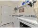 This is a laundry room featuring a washer, dryer, and ample storage space at 18032 Polo Trl, Bradenton, FL 34211