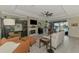 Bright living room with a fireplace, tile flooring, and view of the pool at 18032 Polo Trl, Bradenton, FL 34211