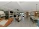 Open living area featuring a brick fireplace, ceiling fan, and tile flooring at 18032 Polo Trl, Bradenton, FL 34211