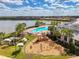 Beautiful community pool, playground, and clubhouse overlooking a serene lake at 18032 Polo Trl, Bradenton, FL 34211
