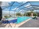 The screened-in pool area features a jacuzzi, and overlooks the lake for a relaxing experience at 18032 Polo Trl, Bradenton, FL 34211