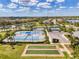 Community tennis courts and amenities surrounded by lush greenery and beautiful landscaping at 18032 Polo Trl, Bradenton, FL 34211