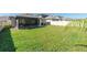 Spacious backyard featuring a well-maintained lawn, screened patio, and privacy fence at 22111 Nebula Way, Land O Lakes, FL 34637